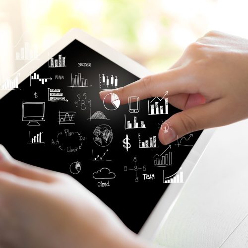 Woman hand hold white tablet with graph and chart symbols